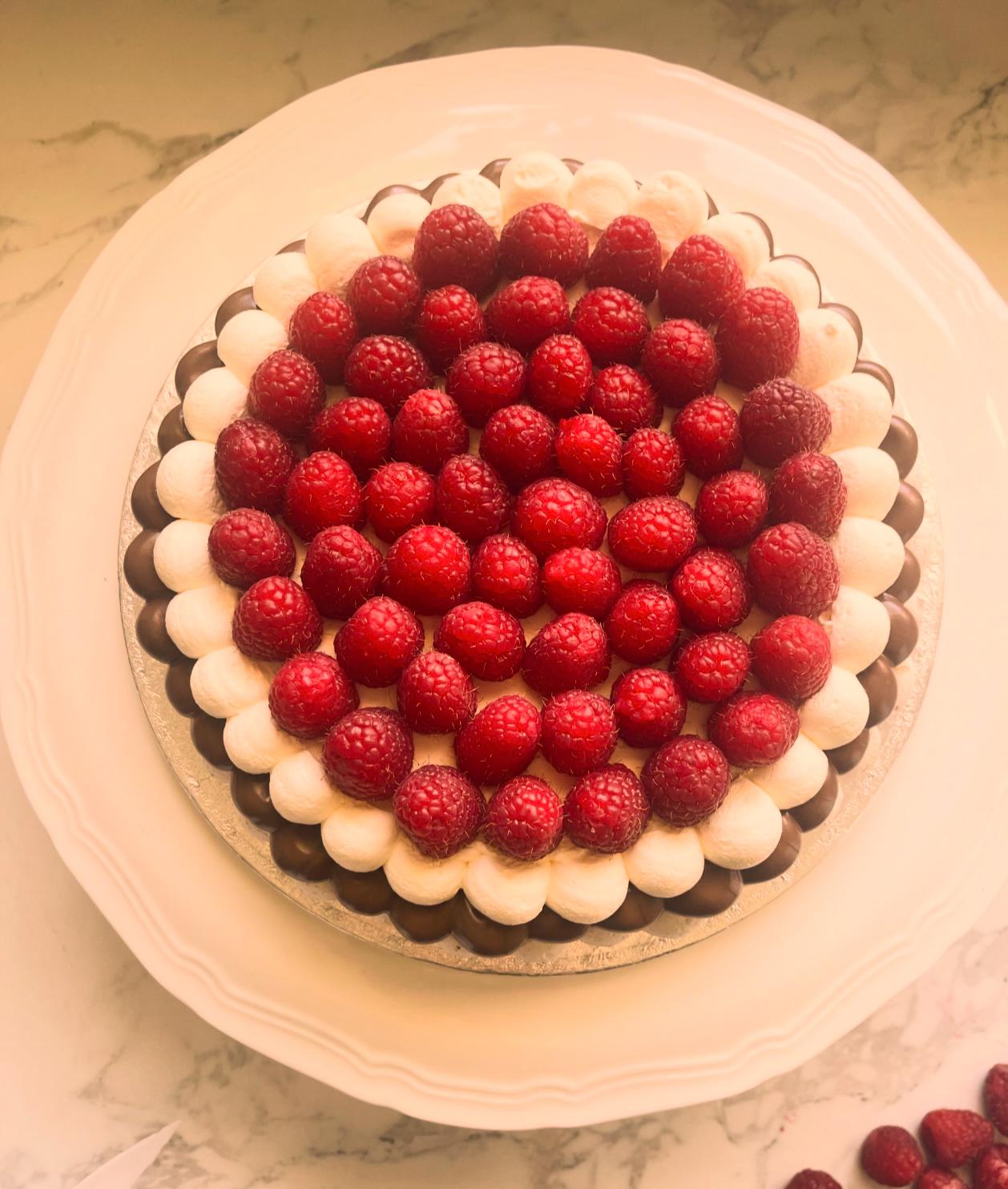 Raspberry Pavlova — Whole fresh raspberries arranged in a striking dome pattern atop our crisp merin